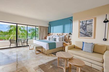 king size bed in resort with couch and table